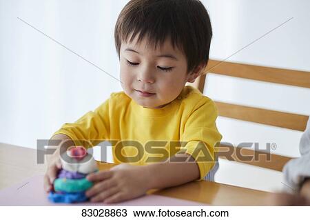 Stock Image - Japanese father and kid playing. Fotosearch