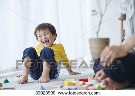 Stock Image - Japanese father and kid playing. Fotosearch