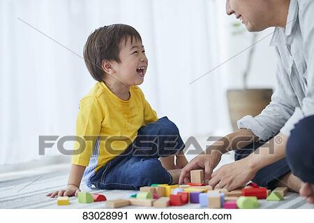 Stock Image - Japanese father and kid playing. Fotosearch
