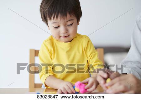 Stock Photo - Japanese father and kid playing. Fotosearch