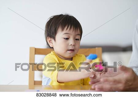 Stock Photo - Japanese father and kid playing. Fotosearch