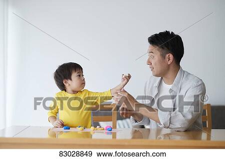Stock Photo - Japanese father and kid playing. Fotosearch