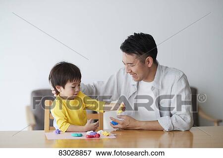 Stock Photo - Japanese father and kid playing. Fotosearch