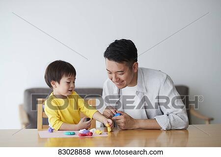Stock Photo - Japanese father and kid playing. Fotosearch
