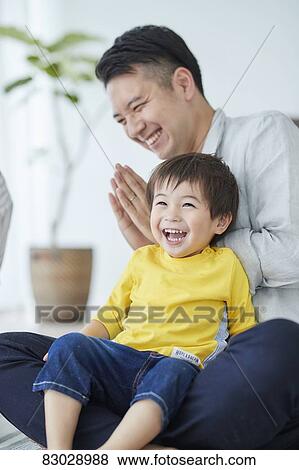 Stock Photo - Japanese father and kid playing. Fotosearch