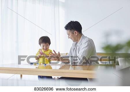 Stock Photograph - Japanese father and kid playing. Fotosearch