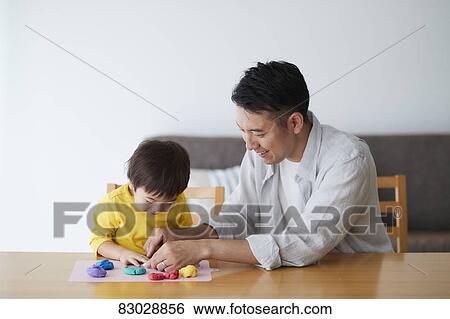 Stock Photograph - Japanese father and kid playing. Fotosearch