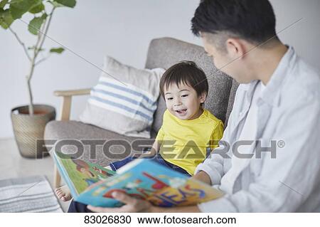 Japanese father and kid reading on the sofa View Large Photo Image Stock Image - Japanese father and kid reading on the sofa. Fotosearch