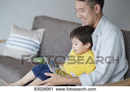 Japanese father and kid reading on the sofa View Large Photo Image Stock Image - Japanese father and kid reading on the sofa. Fotosearch