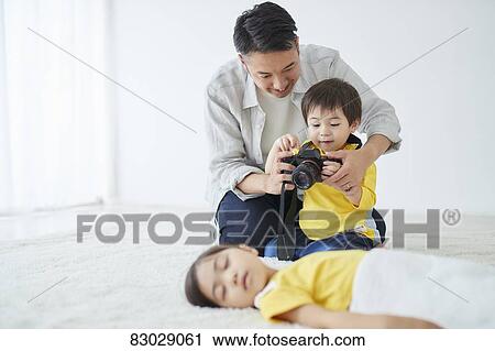 Japanese father and kid taking pictures View Large Photo Image Stock Image - Japanese father and kid taking pictures. Fotosearch