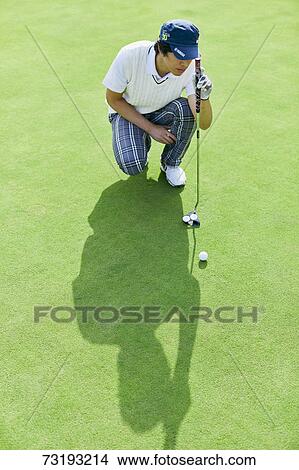 Picture - Japanese golf player on course. Fotosearch