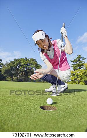 Stock Image - Japanese golf player on course. Fotosearch