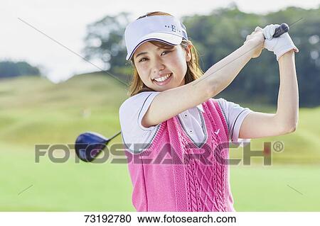 Stock Image - Japanese golf player on course. Fotosearch