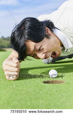 Stock Image - Japanese golf player on course. Fotosearch