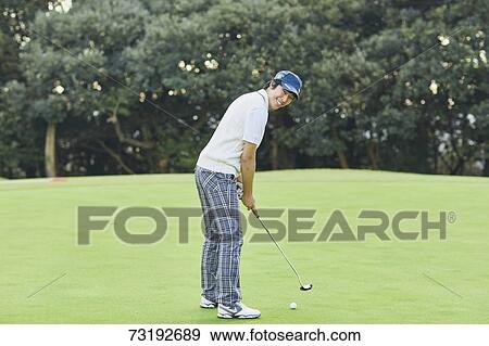 Stock Photo - Japanese golf player on course. Fotosearch