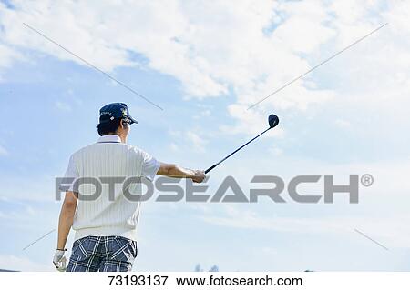 Stock Photo - Japanese golf player on course. Fotosearch