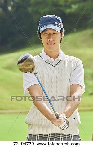 Stock Photo - Japanese golf player on course. Fotosearch