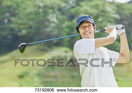 Stock Photograph - Japanese golf player on course. Fotosearch