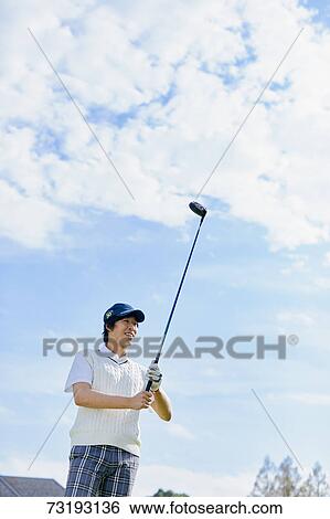 Stock Photograph - Japanese golf player on course. Fotosearch