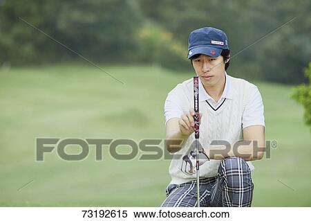 Stock Photography - Japanese golf player on course. Fotosearch