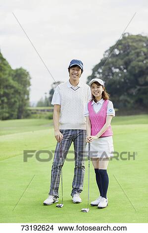 Picture - Japanese golf players on course. Fotosearch