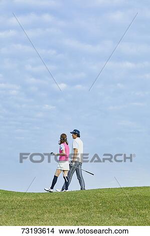 Picture - Japanese golf players on course. Fotosearch