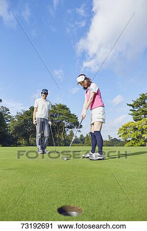 Japanese golf players on course View Large Photo Image Stock Image - Japanese golf players on course. Fotosearch