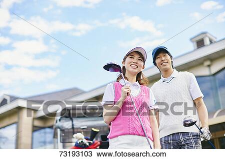 Stock Image - Japanese golf players on course. Fotosearch