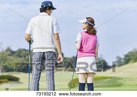Stock Image - Japanese golf players on course. Fotosearch