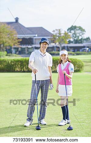 Stock Image - Japanese golf players on course. Fotosearch