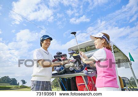 Stock Image - Japanese golf players on course. Fotosearch