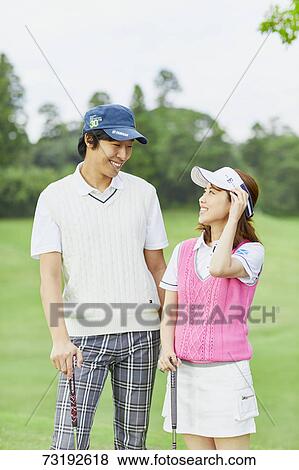 Stock Photo - Japanese golf players on course. Fotosearch