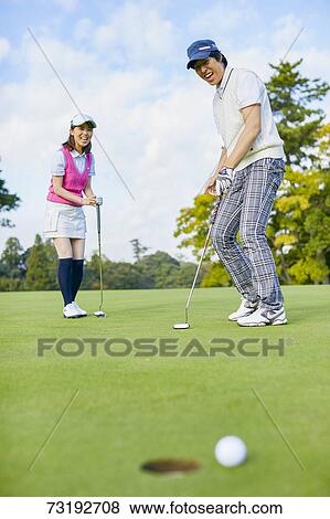 Stock Photo - Japanese golf players on course. Fotosearch