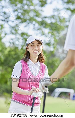 Stock Photo - Japanese golf players on course. Fotosearch