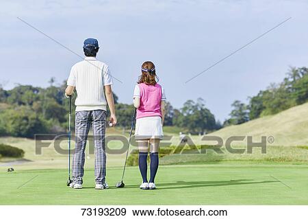 Stock Photo - Japanese golf players on course. Fotosearch