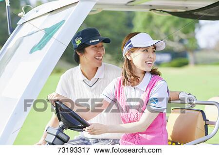 Stock Photo - Japanese golf players on course. Fotosearch