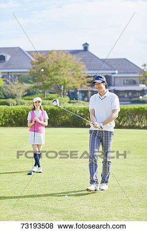 Stock Photo - Japanese golf players on course. Fotosearch