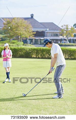 Stock Photo - Japanese golf players on course. Fotosearch