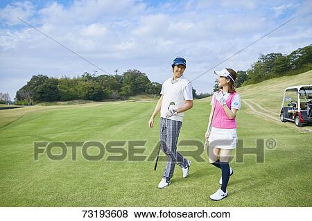 Stock Photo - Japanese golf players on course. Fotosearch
