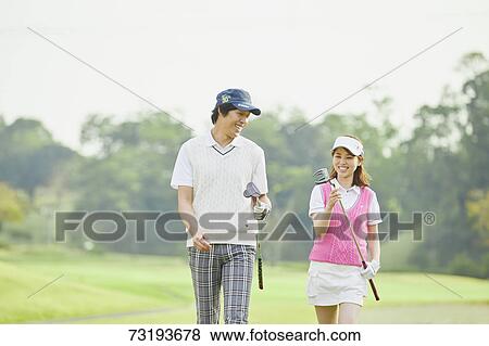 Stock Photo - Japanese golf players on course. Fotosearch