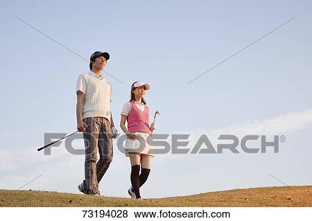 Stock Photo - Japanese golf players on course. Fotosearch