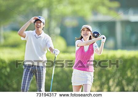 Stock Photo - Japanese golf players on course. Fotosearch