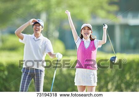 Stock Photo - Japanese golf players on course. Fotosearch