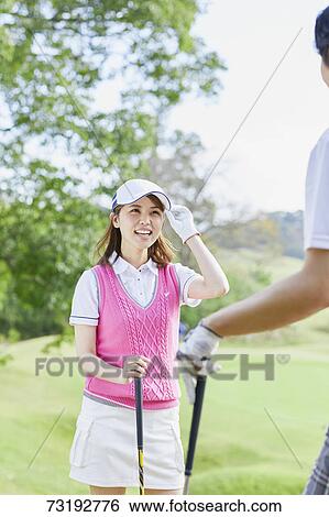 Stock Photograph - Japanese golf players on course. Fotosearch