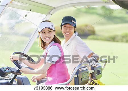 Stock Photograph - Japanese golf players on course. Fotosearch