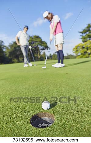 Stock Photography - Japanese golf players on course. Fotosearch