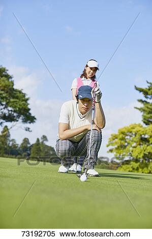 Stock Photography - Japanese golf players on course. Fotosearch