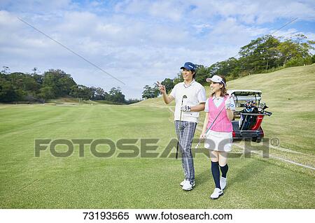 Stock Photography - Japanese golf players on course. Fotosearch