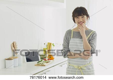 Picture - Japanese housewife in the kitchen. Fotosearch