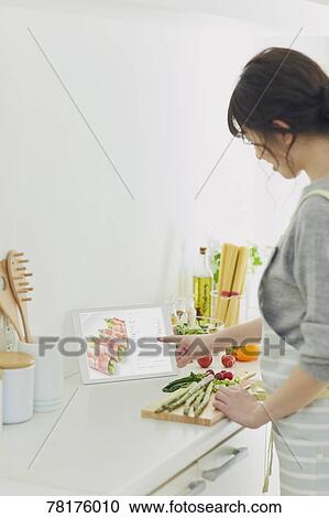 Stock Image - Japanese housewife in the kitchen. Fotosearch